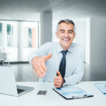 Financial Advisor Reaching Out To Shake Clients Hand