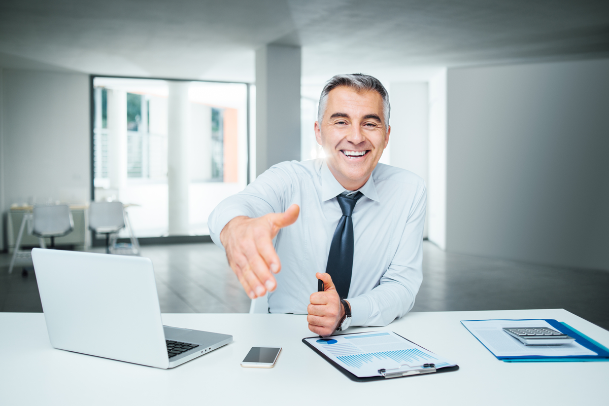 Financial Advisor Reaching Out To Shake Clients Hand