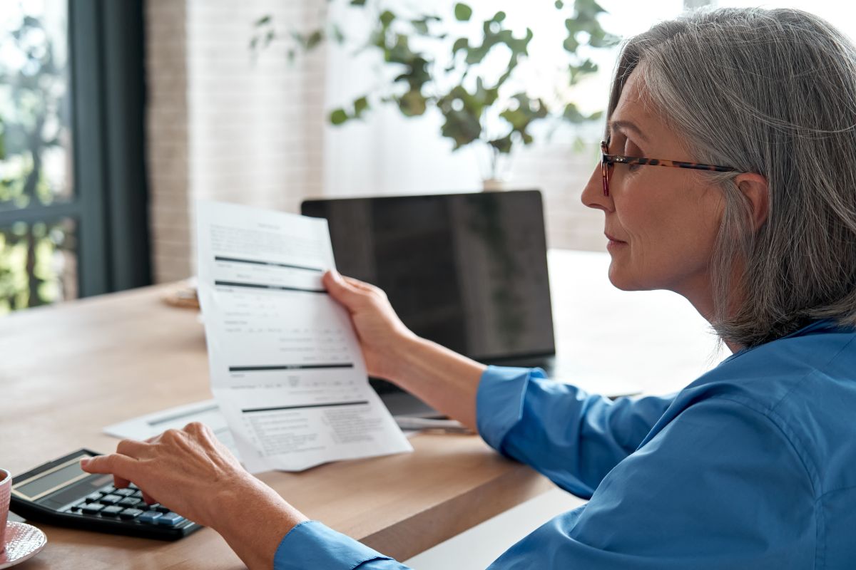 Federal Employee Looking At Her Retirement Benefits Paperwork