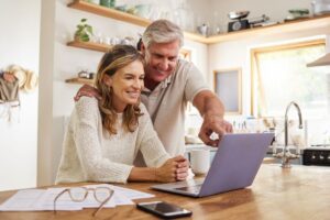 Couple Looking At When They Can Retire On The Computer